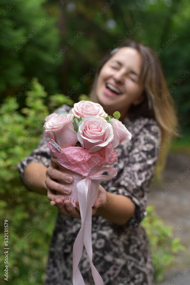 Fototapeta premium Young girl with a bouquet of roses