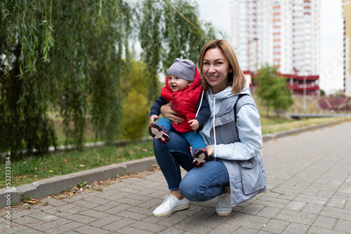 happy young mother on the background of the city with her little child © Ivan Traimak