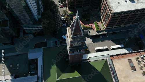 Rising aerial view looking down at the King Street Station Clock in Seattle.