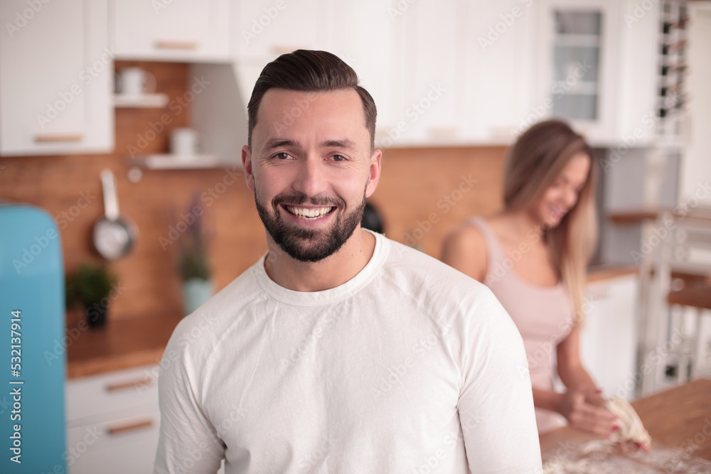 smiling man with a Cup of tea standing in the kitchen smiling man with a Cup of tea standing in the kitchen