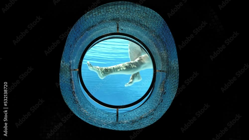 Woman Showing Her Legs in the Ship Porthole in Underwater in Swimming Pool in a Sunny Day in Switzerland. Woman Showing Her Legs in the Ship Porthole in Underwater in Swimming Pool in a Sunny Day in Switzerland.