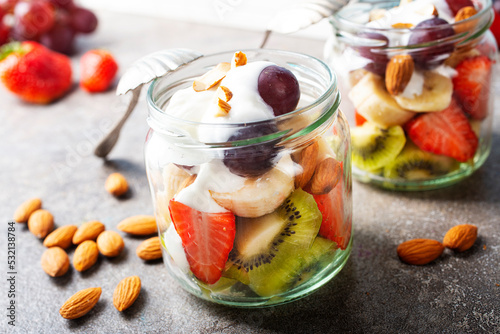 Summer fruit salad with white cream and almonds photo