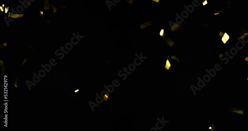 Falling foil confetti with gold glitter on a black background.