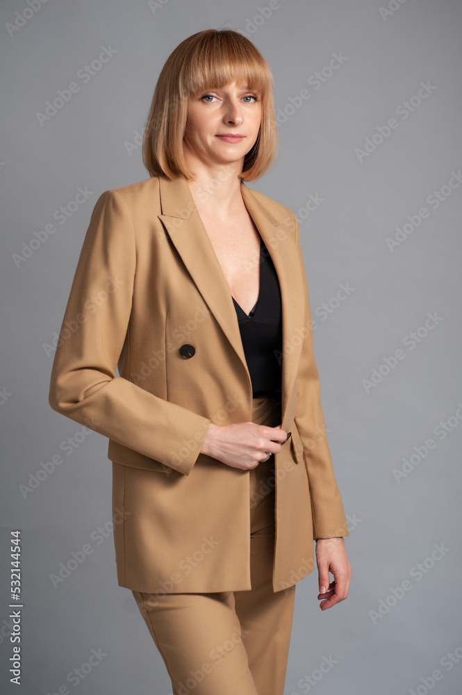 Businesswoman beige formal suit on background Businesswoman beige formal suit on background