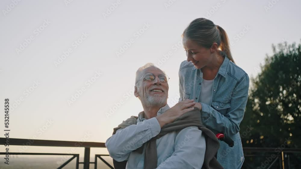 Happy woman shares moments with disabled elderly father Happy woman shares moments with disabled elderly father