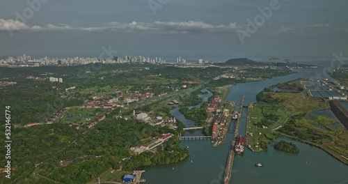 Panama City Aerial v38 descending flyover miraflores lake capturing cargo ships transiting at locks canal with cityscape in distance background along skyline - Shot with Mavic 3 Cine - March 2022 photo