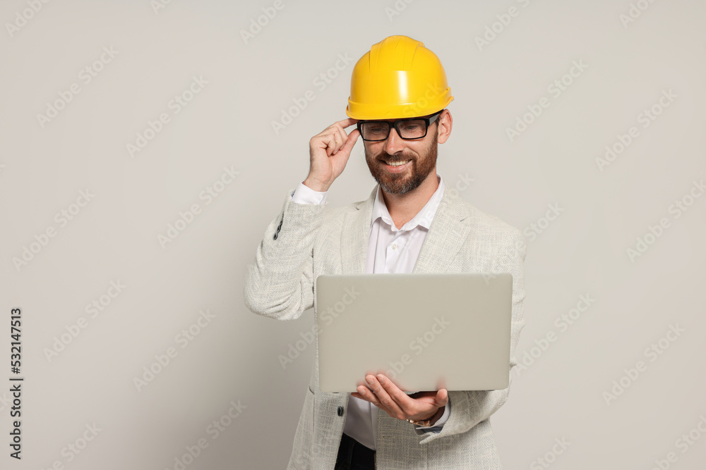 Professional engineer in hard hat with laptop on white background Professional engineer in hard hat with laptop on white background