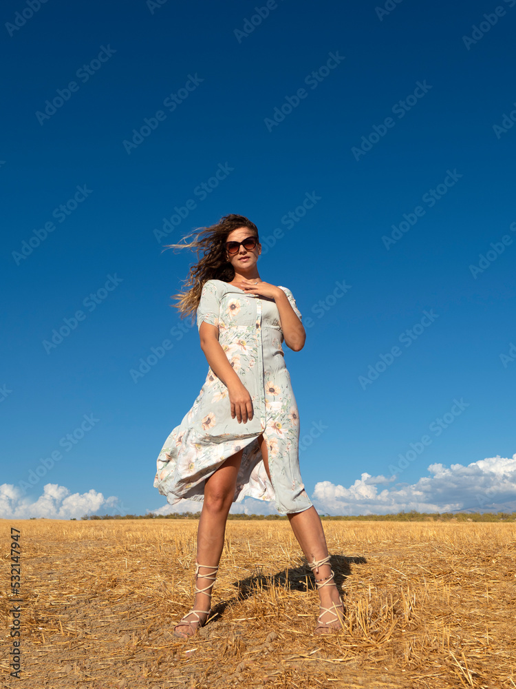 Carefree woman in summer dress in field Carefree woman in summer dress in field