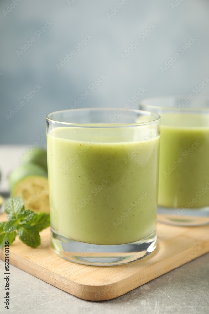 Fresh feijoa smoothie in glass on wooden board, closeup Fresh feijoa smoothie in glass on wooden board, closeup