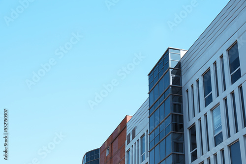 View of modern building against blue sky. Space for text