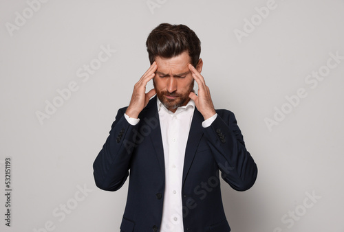 Worried bearded man on light grey background