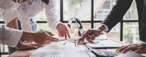 Young colleagues discussing business and price chart analyzes business people on the table great in modern coworking office teamwork concept. Calculate personal tax for customers