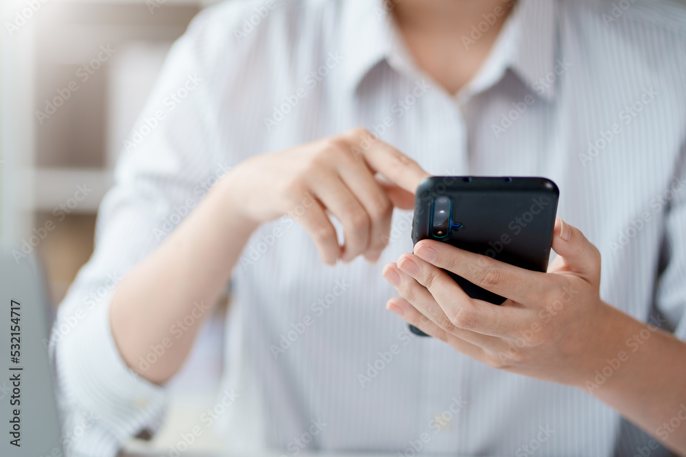 Close-up of a woman using a smartphone to work on various social media applications. including mobile transactions and LINE messaging and other business information via LINE.