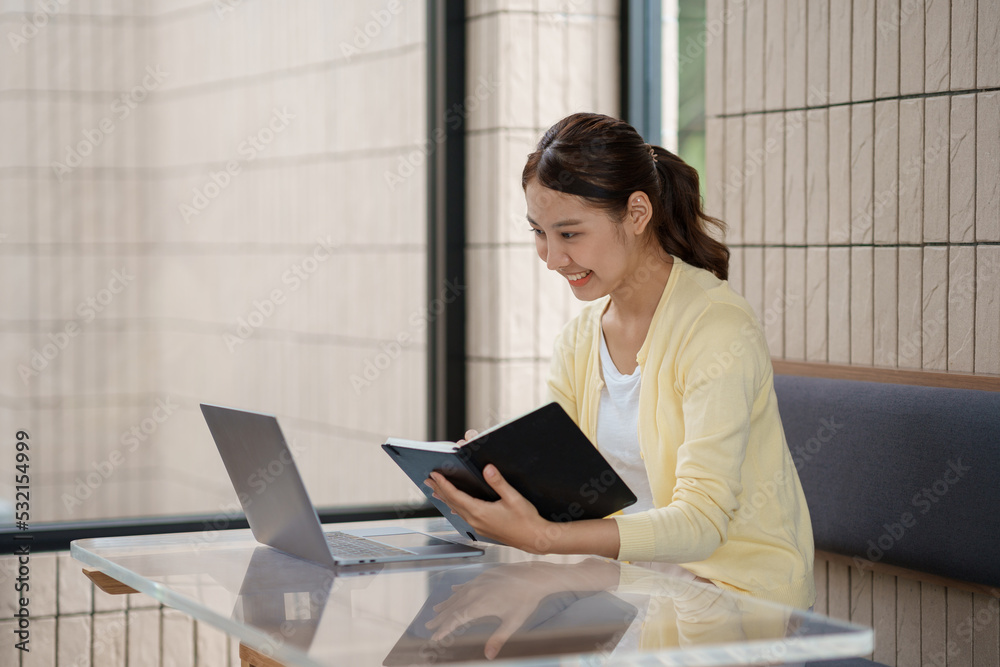 Attractive and beautiful Asian women are reading book and working in cafe at their leisure and enjoying reading on vacation. Attractive and beautiful Asian women are reading book and working in cafe at their leisure and enjoying reading on vacation.