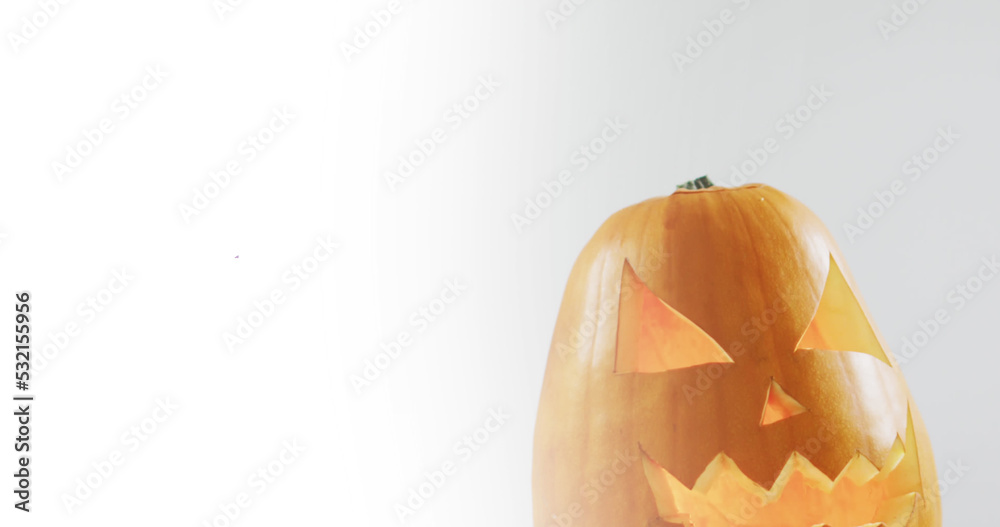 Obraz premium Image of halloween text over carved pumpkin on grey background