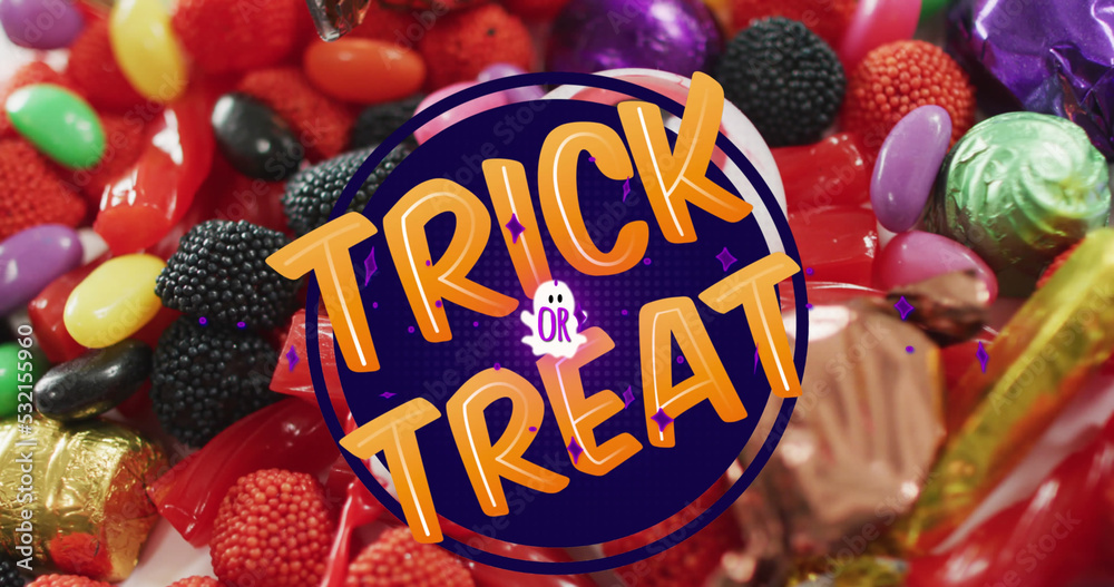 Naklejka premium Image of halloween trick or treat text over sweets background