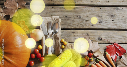 Image of halloween pumpkin and autumn produce on wooden background