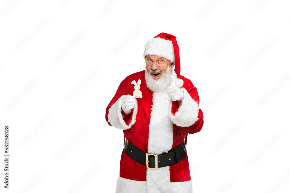 Portrait of senior man in image of Santa Claus posing with decorative rabbit isolated over white background Portrait of senior man in image of Santa Claus posing with decorative rabbit isolated over white background