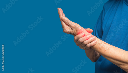 Schilderij op canvas Hands senior woman suffering from wrist pain while standing on a blue background