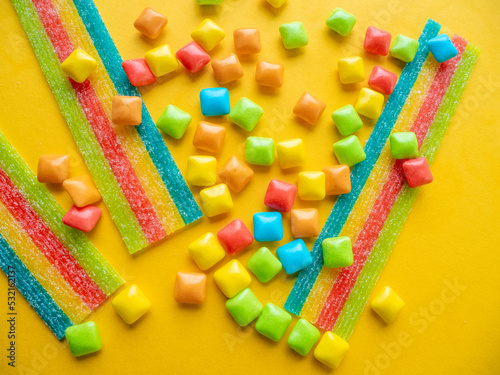 Obraz na płótnie Multicolored marmalade sweets on a yellow background.
w salonie