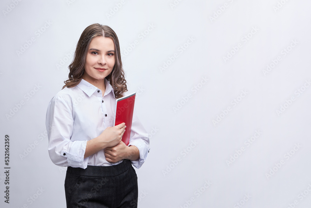A young brunette woman, in an office outfit, in trousers and a white blouse. On a white background, isolate. A young brunette woman, in an office outfit, in trousers and a white blouse. On a white background, isolate.