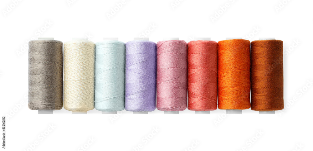 Set of different colorful sewing threads on white background, top view Set of different colorful sewing threads on white background, top view