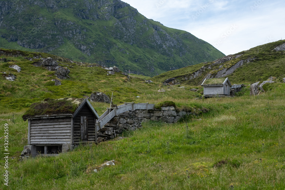 Wonderful landscapes in Norway. Vestland. Beautiful scenery of old waterdriven mills at Krakenes. Grassy roofs. Scandinavian landscape. Cloudy day. Selective focus