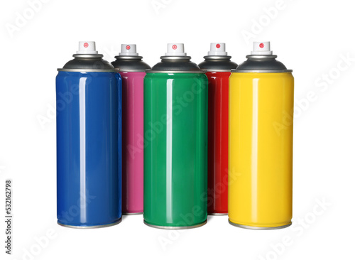 Colorful cans of spray paints on white background