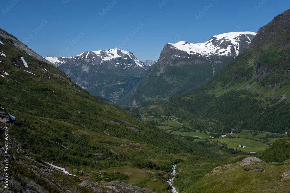 Wonderful landscapes in Norway. Vestland. Beautiful scenery of mountain valley in Djupevatn on the Geiranger -Trollstigen scenic route. Snowed mountains and winding roads in background Selective focus