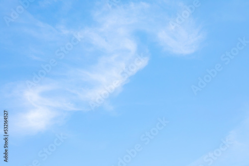 Blue sky background and white clouds soft focus, and copy space horizontal shape.