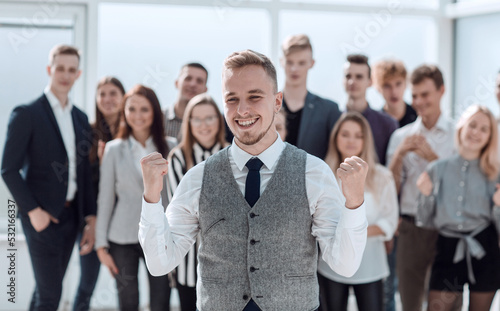 happy leader standing in front of the business team