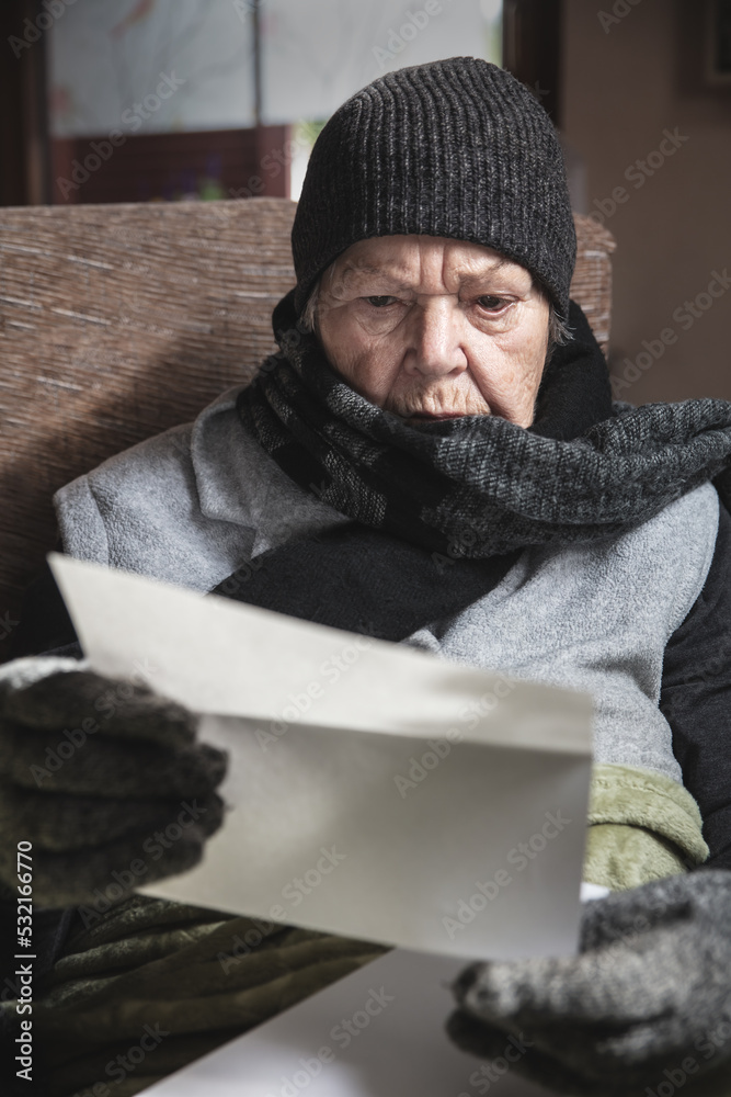 pensioner is sitting with winter clothes indoors pensioner is sitting with winter clothes indoors