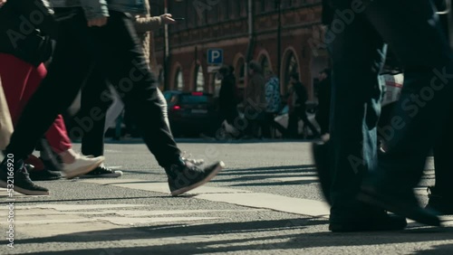 crowd of people walks down the street of the city