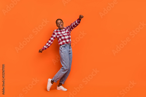 Full size photo of overjoyed satisfied person enjoy disco clubbing isolated on orange color background