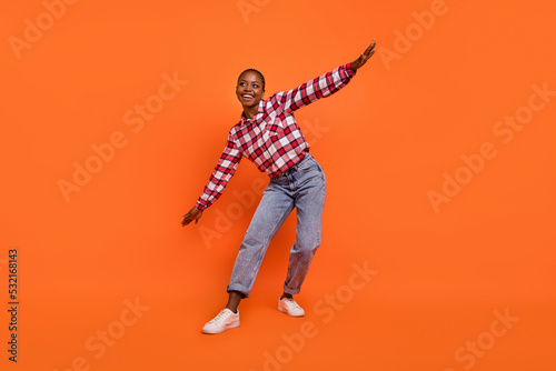 Full length photo of cheerful nice person dancing chilling spend pastime isolated on orange color background