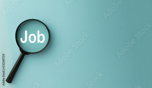 Looking for new job,career,Human Resource Management Concept.,Magnifying glass with Job word over blue sky background left side with copyspace for put your text or logo.