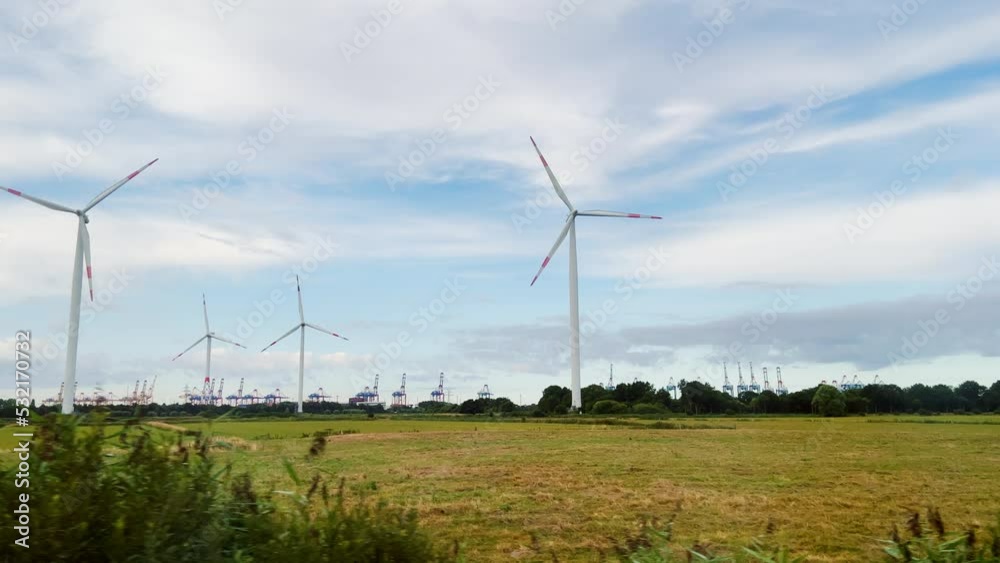 Wind turbines in front of an industrial harbour in northern Germany. Wind turbines in front of an industrial harbour in northern Germany.