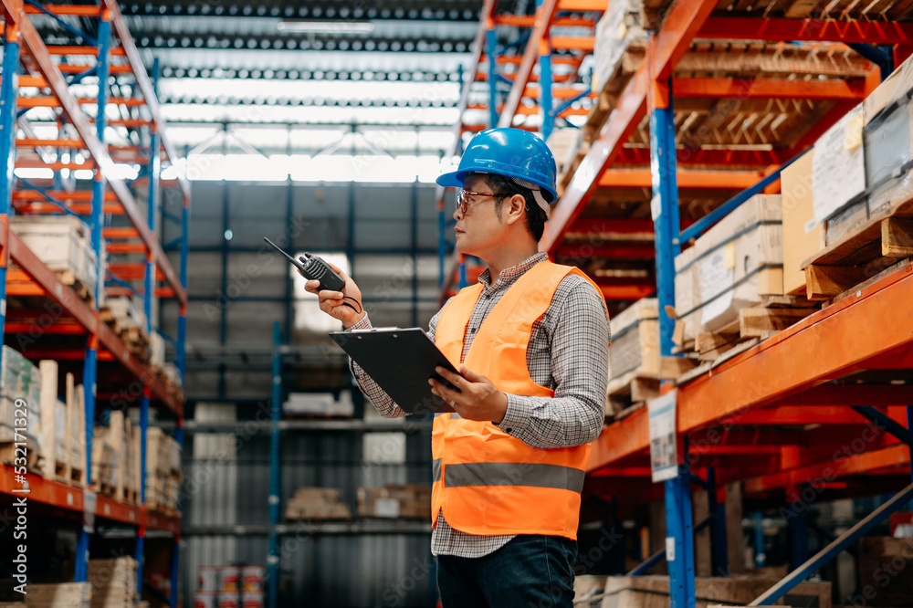 Storage worker in uniform and notepad,digital tablet in hands checks production. warehouse concept. Storage worker in uniform and notepad,digital tablet in hands checks production. warehouse concept.