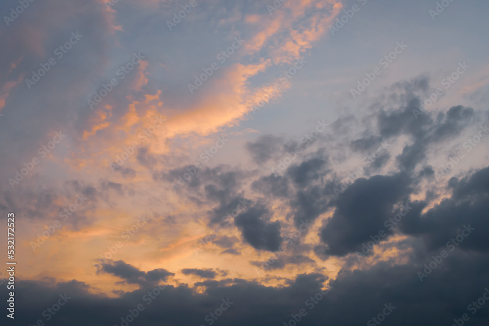 Sunset sky with black and yellow clouds. Nature background image
