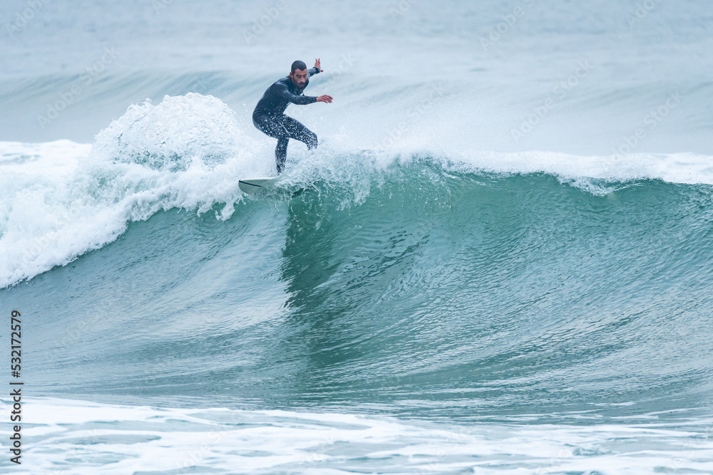 Surfing on turquoise wave in ocean Surfing on turquoise wave in ocean