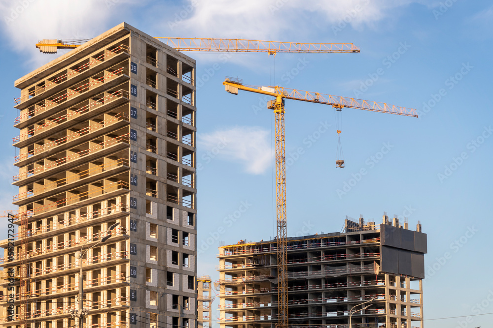 Construction site with 2 cranes on bright sunny day. Construction site with 2 cranes on bright sunny day.