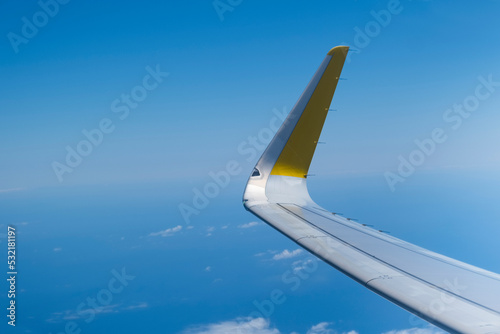 airplane wing flying over the blue sky