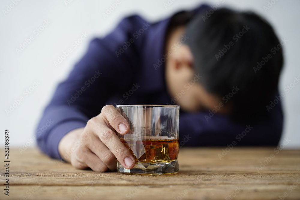 Businessman handshake after make deal, alcoholism, alcohol addiction and people concept - male alcoholic with glass of whiskey lying or sleeping on table Businessman handshake after make deal, alcoholism, alcohol addiction and people concept - male alcoholic with glass of whiskey lying or sleeping on table