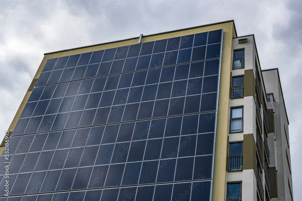 Obraz premium solar panels on the wall of a multi-storey building. Renewable solar energy.