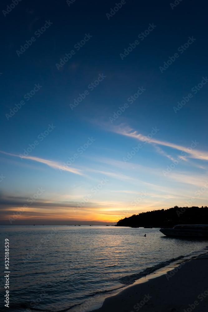 Fototapeta premium Golden sunset and dark blue sky with silhouette island and sea vertical style at Thailand