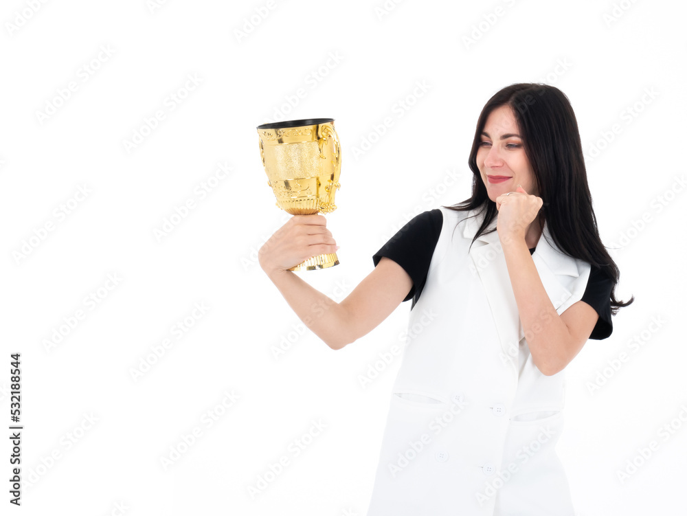 Caucasian winner girl smile proudly when see the golden trophy cup in her hand isolated on white background Caucasian winner girl smile proudly when see the golden trophy cup in her hand isolated on white background