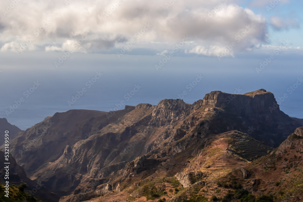 Panoramic view on Rocky Mountain peaks and the hilly landscape on the way to Valle Gran Rey, La Gomera, Canary Islands, Spain, Europe. Remote coastline of the Atlantic Ocean. Peaceful, silent location Panoramic view on Rocky Mountain peaks and the hilly landscape on the way to Valle Gran Rey, La Gomera, Canary Islands, Spain, Europe. Remote coastline of the Atlantic Ocean. Peaceful, silent location