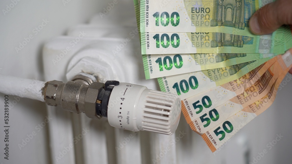 Europe, Italy , Increase in the cost of bill for  gas and electricity causes increased price for the procurement of raw materials, money 100, 50 euro banknote and domestic heating radiator