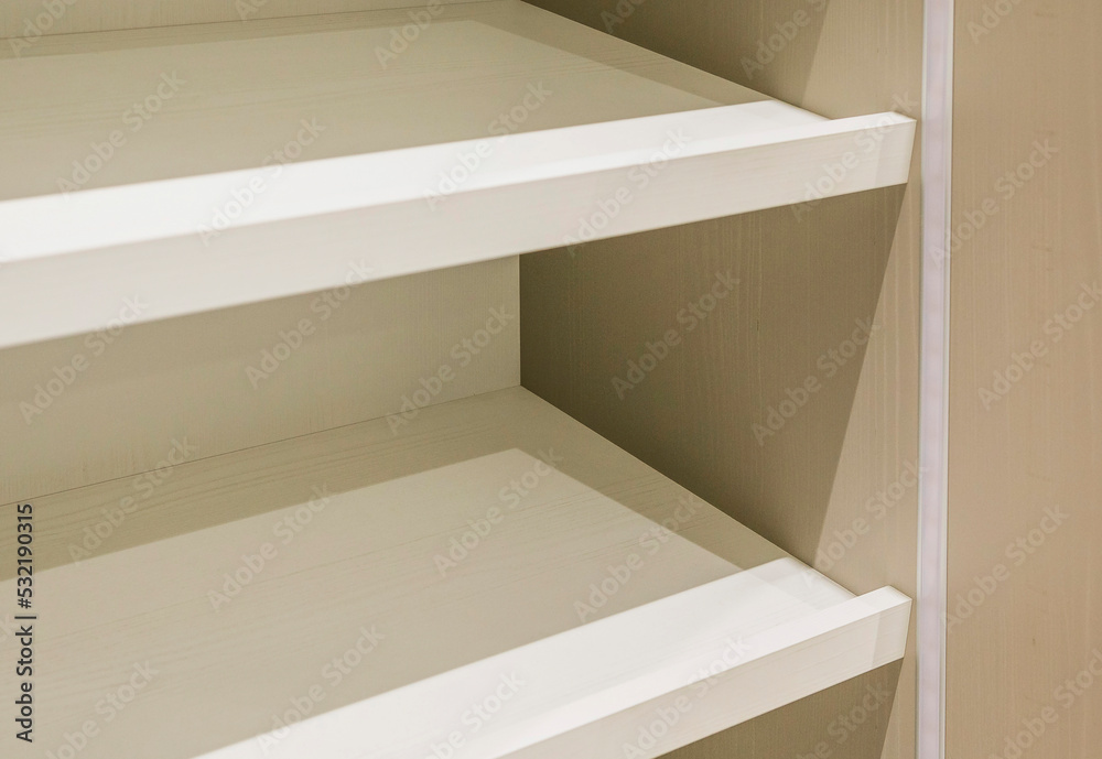 Obraz premium White shelves of the new cabinet