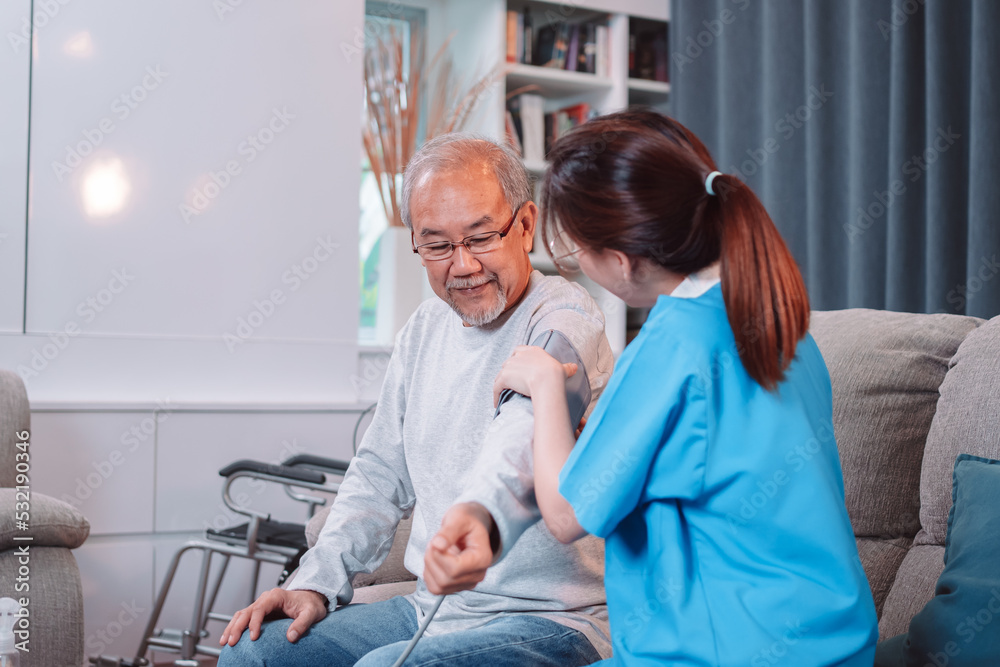 Obraz premium Asian caregiver doctor examine older patient use blood pressure gauge. nurse visit and taking care patient senior man checkup elderly old man in living room, Healthcare insurance concept.